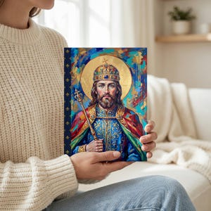 View of St. Stephen of Hungary lined journal, with the prayer typeset on the back cover, navy and gold fleur-de-lis spine, model in living room