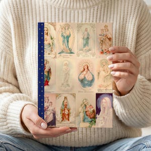 Detail of Queenship of Mary lined journal, with the prayer typeset on the back cover, navy and gold star spine, model close-up