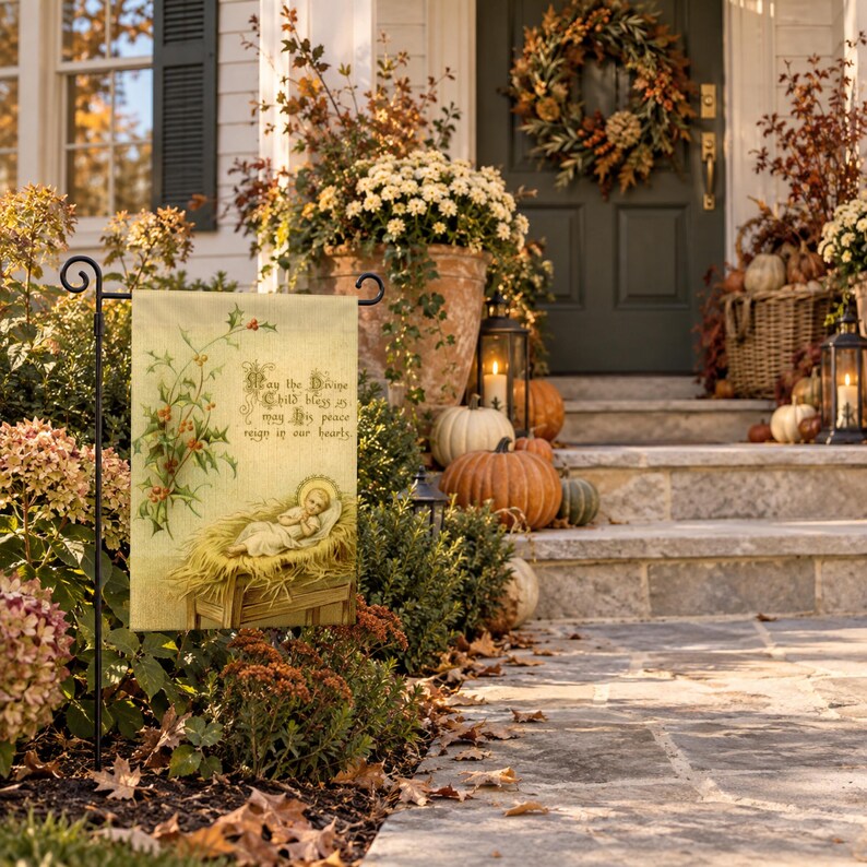 Nativity garden flag on a garden stand by porch steps with pumpkins, mums and an autumn wreath