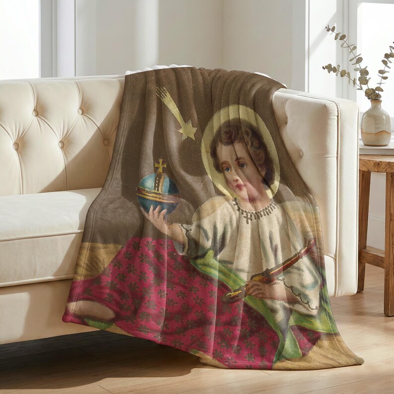 Christmas plush blanket draped over the arm of a tufted cream sofa