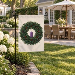 Advent garden flag on a garden stand at the edge of a lawn beside a patio table