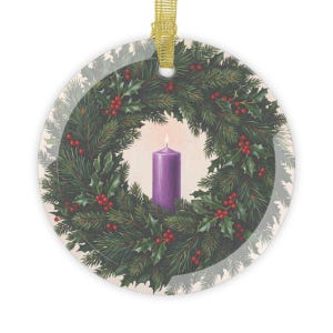 Round glass ornament with gold ribbon hanger featuring an illustration of a purple candle centered in a wreath of evergreen branches, holly leaves, and red berries, representing the First Sunday of Advent