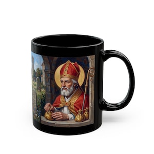 Black mug featuring an illustration of St. Nicholas wearing red robes, a red and gold bishop's mitre, and holding a golden staff, with a halo behind his head and a cathedral interior in the background