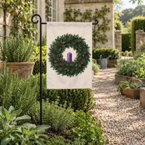 Advent garden flag on a garden stand beside a gravel path through an herb garden