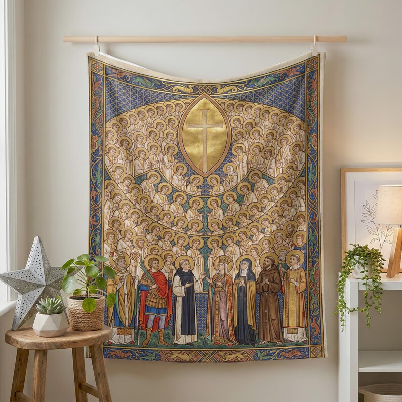 All Saints plush blanket hung on a wall from a wooden rod above a small plant stand