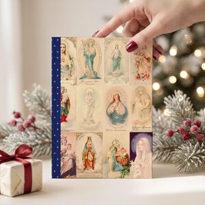Photograph of Queenship of Mary lined journal, with the prayer typeset on the back cover, navy and gold star spine, christmas interior