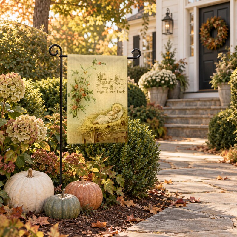Nativity garden flag on a garden stand among autumn hydrangeas and pumpkins by a front walk