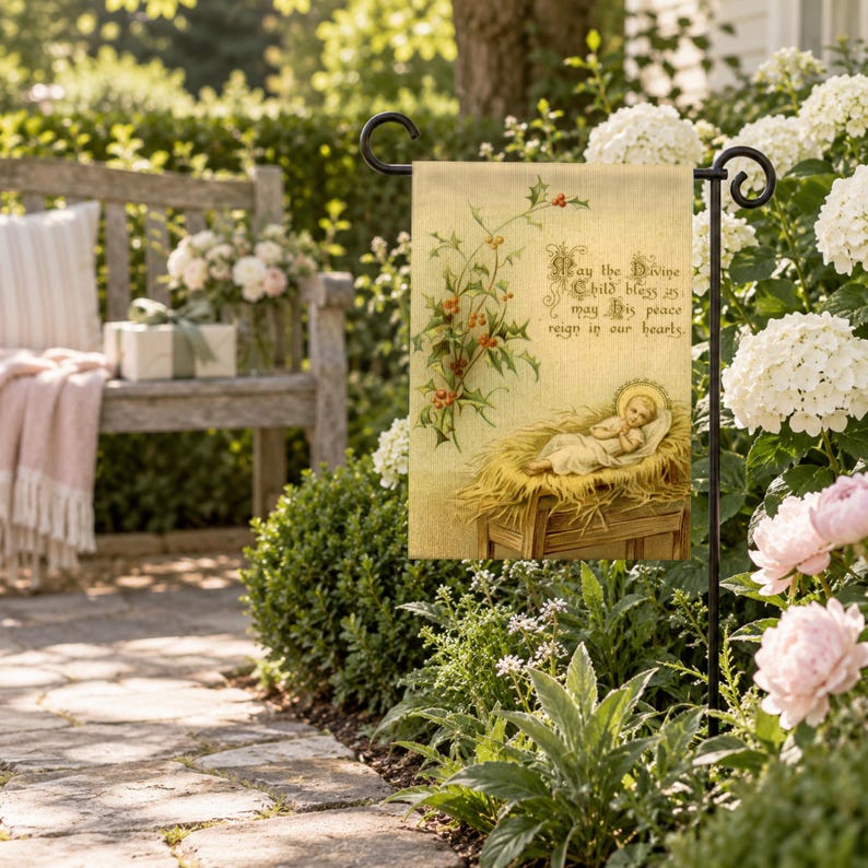Nativity garden flag on a garden stand among white hydrangeas and peonies beside a garden bench