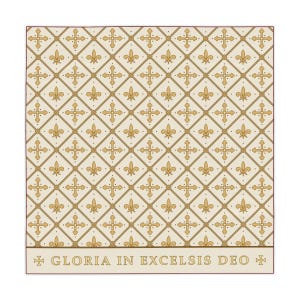 Cream-colored square tablecloth with a diagonal lattice pattern of alternating gold fleur-de-lis and ornate crosses, bordered by text reading 'Gloria in Excelsis Deo'