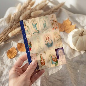 View of Queenship of Mary lined journal, with the prayer typeset on the back cover, navy and gold star spine, halloween interior