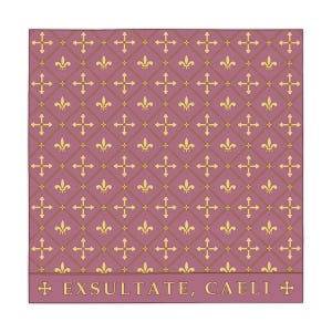 A 55 x 55 tablecloth with a mauve background featuring a repeating pattern of gold fleur-de-lis and ornate crosses arranged in diamond shapes, with text reading 'EXSULTATE, CAELI' along the bottom border