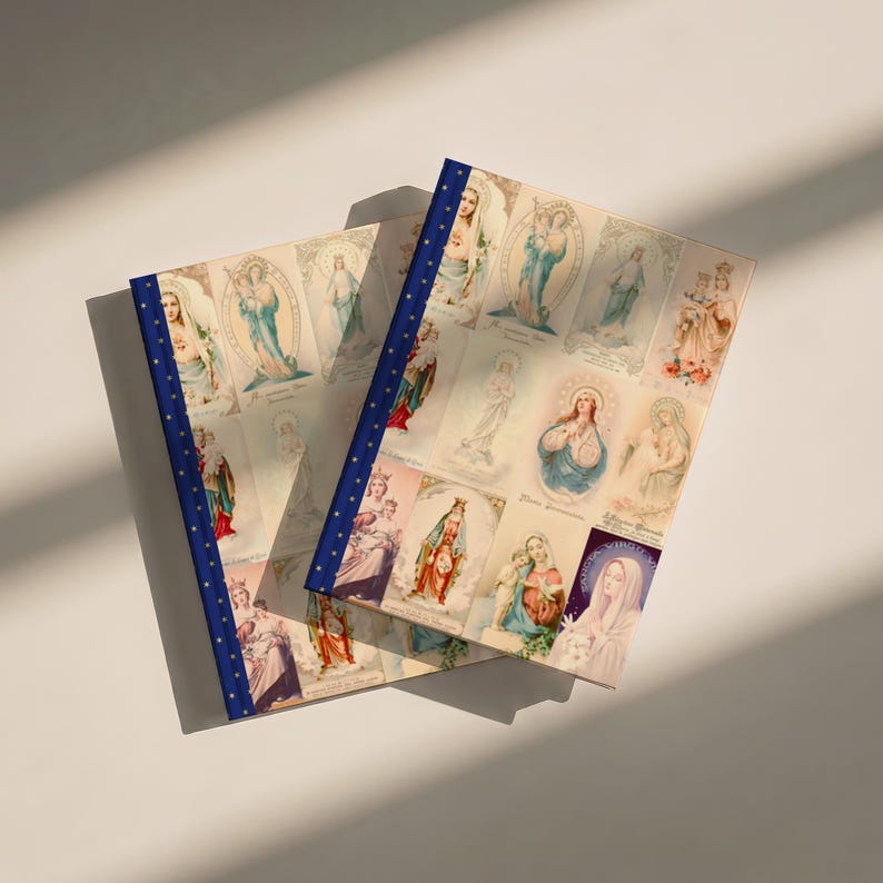 Another view of Queenship of Mary lined journal, with the prayer typeset on the back cover, navy and gold star spine, two journals