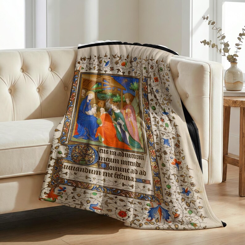Nativity plush blanket draped over the arm of a tufted cream sofa