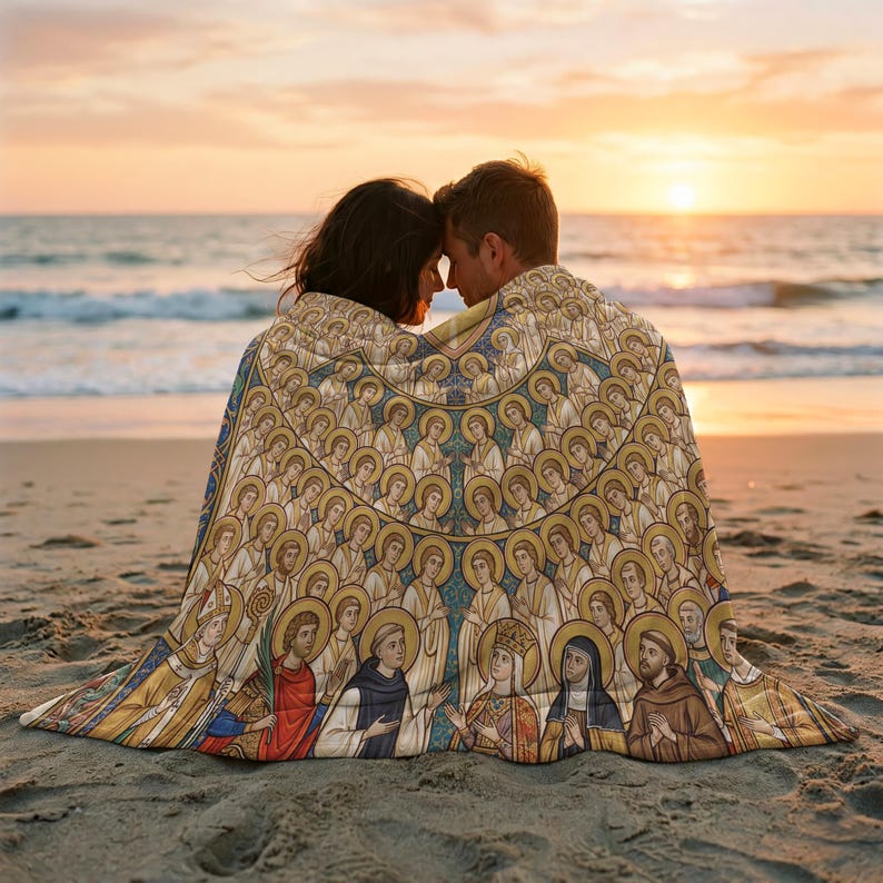All Saints plush blanket wrapped around a couple on the beach at sunset
