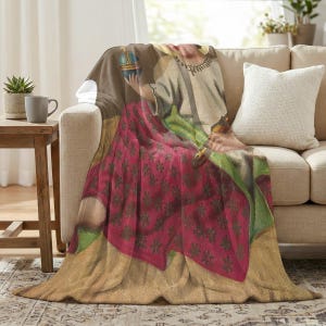 Christmas plush blanket draped over the arm of a cream sofa