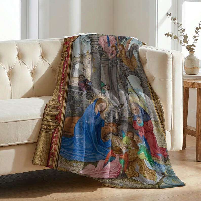 Nativity plush blanket draped over the arm of a tufted cream sofa
