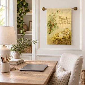 Nativity garden flag hung from a brass rod above a desk in a bright home office