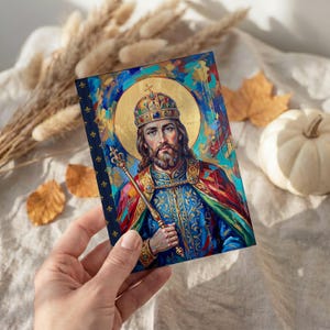 View of St. Stephen of Hungary lined journal, with the prayer typeset on the back cover, navy and gold fleur-de-lis spine, halloween interior
