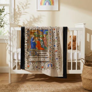 Nativity plush blanket draped over the side of a white crib in a nursery