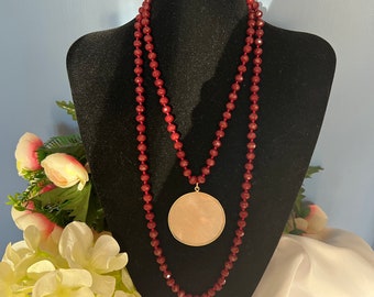 Very long burgundy red crystal necklace and large round rose quartz pendant set in gold metal. Gift for women.