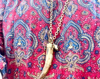 Knurled gold chain and wood-colored horn. Long necklace and bell pendant. Ethnic and exotic style jewelry. Unisex gift.