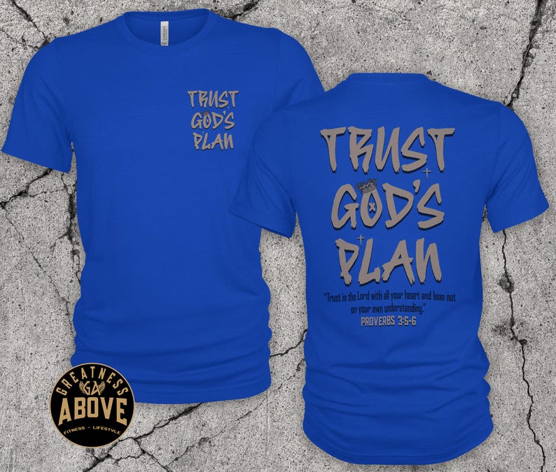 May include: A royal blue short-sleeve t-shirt featuring the text TRUST GOD'S PLAN in grey on the front left chest and in a larger size on the back. The back also includes the text Trust in the Lord with all your heart and lean not on your own understanding. PROVERBS 3:5-6.