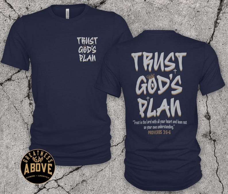 May include: A navy blue short-sleeve t-shirt featuring the text TRUST GOD'S PLAN on the front left chest. The back displays the same text in large letters with a crown and cross icons, plus the verse Trust in the Lord with all your heart and lean not on your own understanding. PROVERBS 3:5-6.