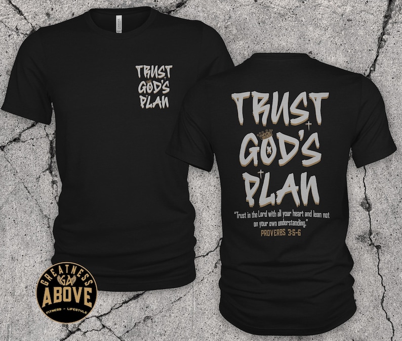 May include: A black short-sleeved t-shirt featuring the text "TRUST GOD'S PLAN" in white and tan on the front left chest and a larger version on the back, which also includes the verse "Trust in the Lord with all your heart and lean not on your own understanding. PROVERBS 3:5-6."