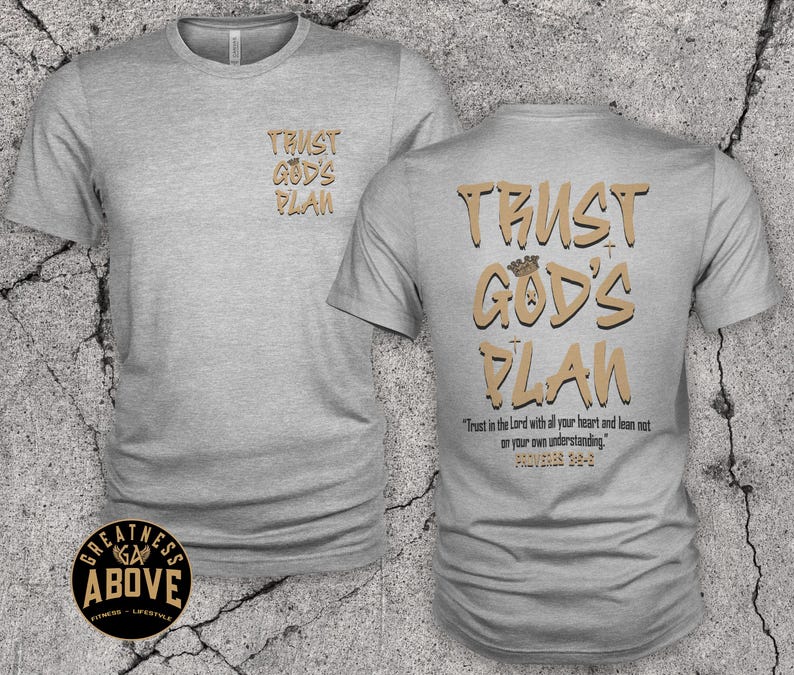 May include: A heather gray short-sleeve t-shirt featuring the text "TRUST GOD'S PLAN" in tan letters on the front left chest and a larger version on the back with a small crown icon, plus the verse "Trust in the Lord with all your heart and lean not on your own understanding. Proverbs 3:5-6."