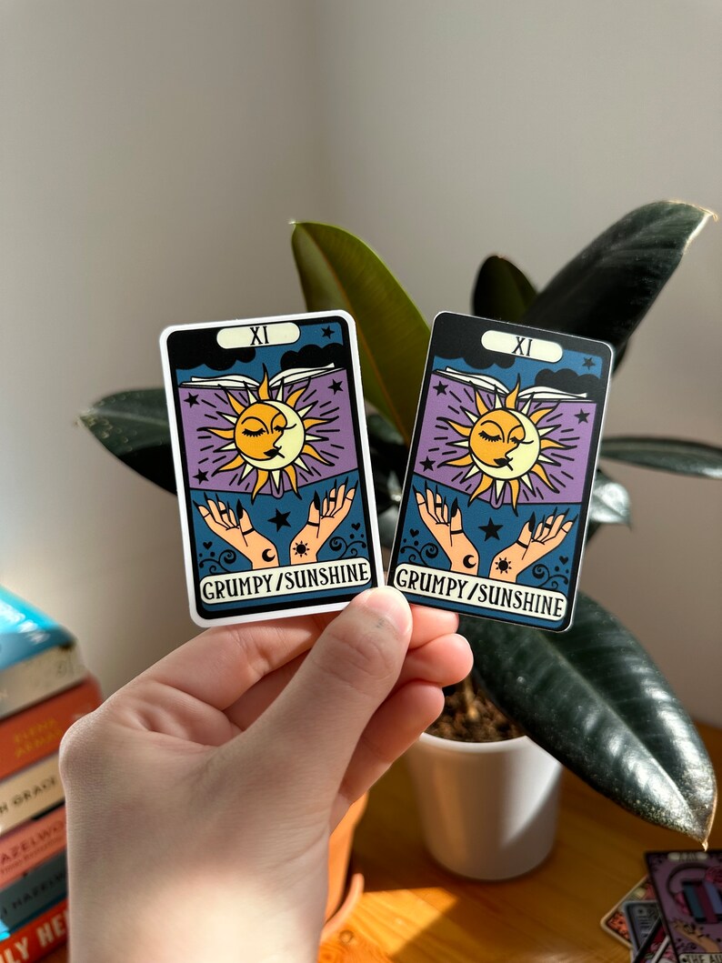 May include: Two tarot card stickers with a sun and moon design. The cards are white with black borders and feature the text "XI GRUMPY/SUNSHINE".