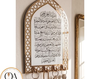 May include: A gold-colored wall hanging with Arabic calligraphy, featuring a decorative geometric border. Below the calligraphy are several key hooks. The design includes the text "LASER CUTTING FILES" and "VECTOR STUDIO".