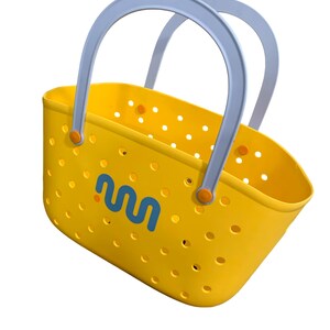 May include: Yellow tote bag with a perforated design and light blue handles. The bag features a blue and orange logo on the side. The handles are attached with orange accents. The bag is designed for carrying items.