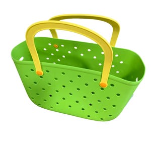 May include: A bright green tote bag with yellow handles. The bag has a perforated design with numerous small, evenly spaced holes. The handles are a contrasting yellow color, attached with orange accents.