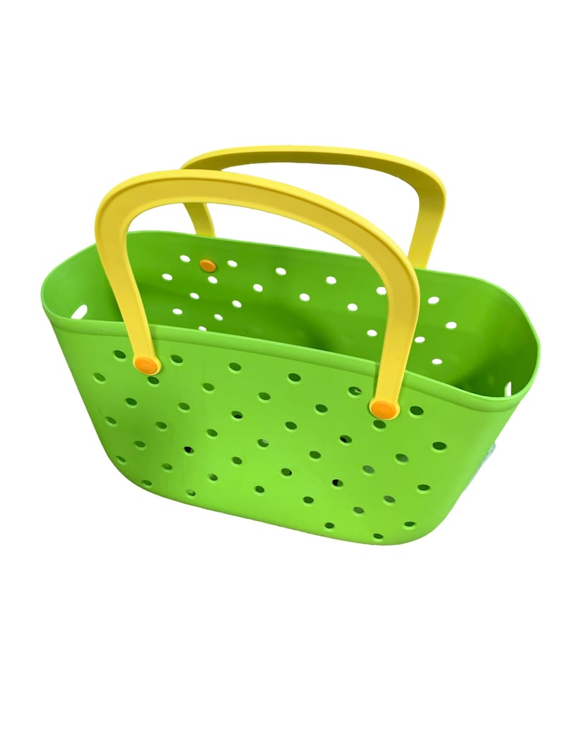 May include: A bright green tote bag with yellow handles. The bag has a perforated design with numerous small, evenly spaced holes. The handles are a contrasting yellow color, attached with orange accents.