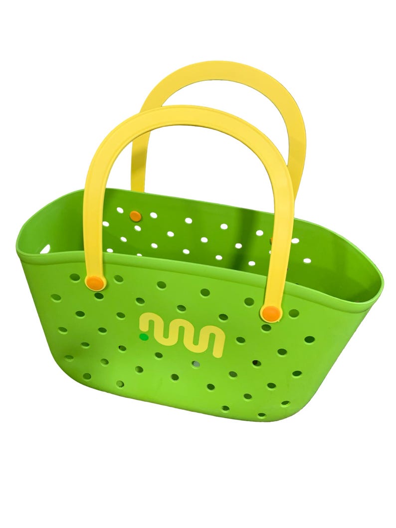 May include: A bright green tote bag with yellow handles. The bag has a perforated design and a yellow logo on the front. The handles are arched and attached with orange fasteners. The bag is designed for carrying items.