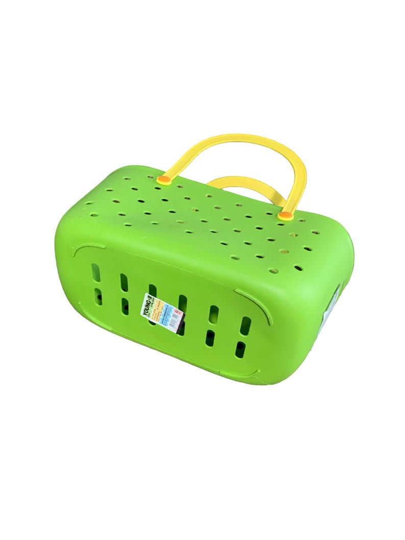 May include: A bright green plastic basket with a yellow handle. The basket has a rectangular shape with numerous small holes and vertical slots. A label is attached to the side.