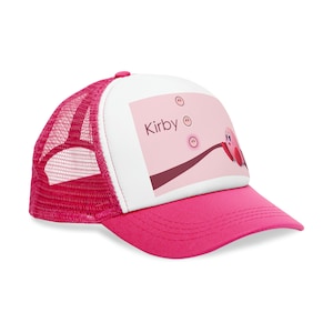 May include: Pink and white trucker hat with a pink Kirby character graphic and the word "Kirby" printed on the front.
