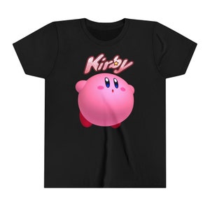 May include: Black t-shirt featuring a pink Kirby character graphic and the word "Kirby" in red and white lettering.