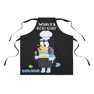 May include: Black apron featuring a cartoon dog wearing a chef's hat and holding a wooden spoon and a frying pan. The text "WORLD'S BEST CHEF" is above the dog and "BONJOUR" is below the dog with a green bean.