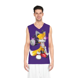 May include: A sleeveless purple V-neck shirt featuring a cartoon character with yellow fur, white accents, and red shoes. The character has a robotic arm and a laser eye. The shirt is worn by a person.