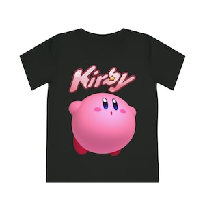 May include: Black t-shirt featuring a pink Kirby character and the word "Kirby" in red and white lettering.
