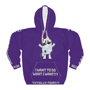 May include: A purple hoodie with a cartoon character on the front. The character is white with black spots and a black and white face. The hoodie has the text "I WANT TO DO WHAT I WANT!!! TOTALLY FAIR!!!" and white text on the sleeves.