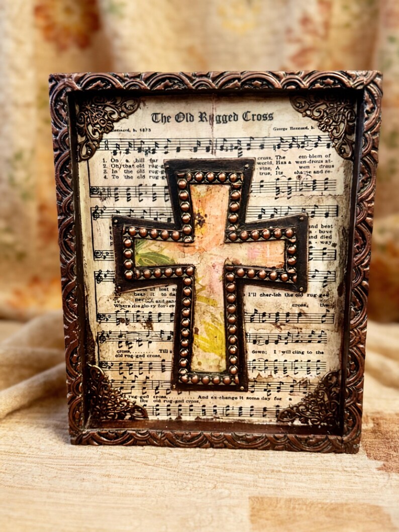 Rustic bedazzled cross set on background of old hymnal