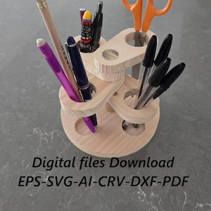 May include: A wooden pencil holder with multiple compartments, holding pencils, pens, and orange scissors. The text "Pencil Holder" is at the top. The text "Digital files Download EPS-SVG-AI-CRV-DXF-PDF" is at the bottom.
