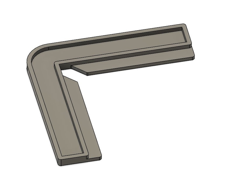 May include: A gray plastic corner brace with a right angle. The brace has a lip on the top and bottom edges.