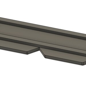 May include: A gray plastic mold for making a rectangular shape with a raised edge.