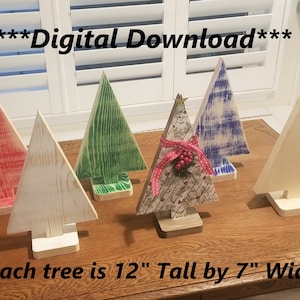 May include: Wooden Christmas tree decorations in various colors, including red, green, blue, and natural wood. Each tree is 12 inches tall and 7 inches wide. Some trees are decorated with ribbon and a star.