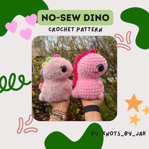 May include: Two pink crocheted dinosaur toys, one with rainbow accents and the other with a pink accent, are held in the hands of a person. The text "NO-SEW DINO CROCHET PATTERN" is above the toys. The text "BY: KNOTS_BY_JAK" is below the toys.