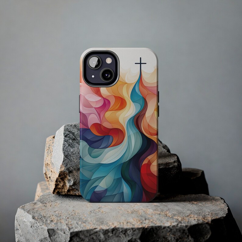May include: A colorful phone case with an abstract design featuring a cross at the top. The design is a mix of blue, red, orange, and yellow.
