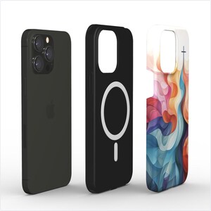 May include: Three phone cases, one black with a white ring in the center, one black with a white ring and a white line at the bottom, and one with a colorful abstract design.